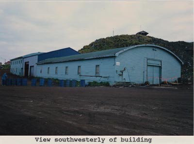 Photo of southwesterly view of low blue building with rounded top.